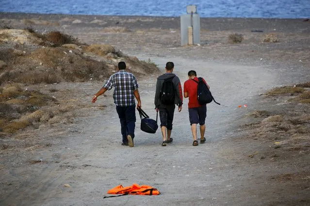 Syrian refugees walk on the Greek island of Kos, after crossing a part of the Aegean sea from Turkey, August 10, 2015. (Photo by Yannis Behrakis/Reuters)