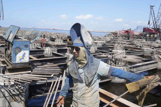 An Egyptian welder works at a new terminal in the Mediterranean harbor of the Delta port city of Alexandria, Egypt, Thursday, August 22, 2024. (Phoot by Amr Nabil/AP Photo)