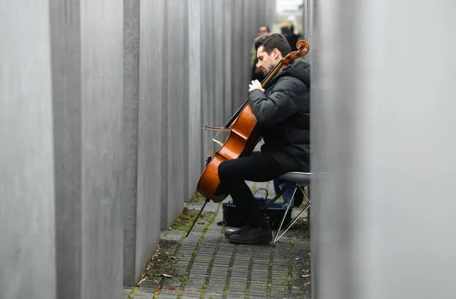 Slovenian Luka Sulic, a member of the Cellisten-Duo “2Cellos”, plays cello at the Holocaust Memorial in Berlin, Germany, January 27, 2020. (Photo by Annegret Hilse/Reuters)