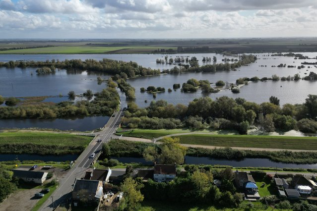 The A1101 at Welney in Norfolk, UK is submerged by flooding on Monday, October 7, 2024 from the Old Bedford River and the River Delph, leaving locals facing a 22 mile diversion. Thunderstorms and heavy rain may cause travel disruption across parts of southern England and Wales, after a yellow thunderstorm warning was issued by the Met Office from Monday afternoon across much of South Wales, South West England, and parts of southern England. (Photo by Joe Giddens/PA Images via Getty Images)