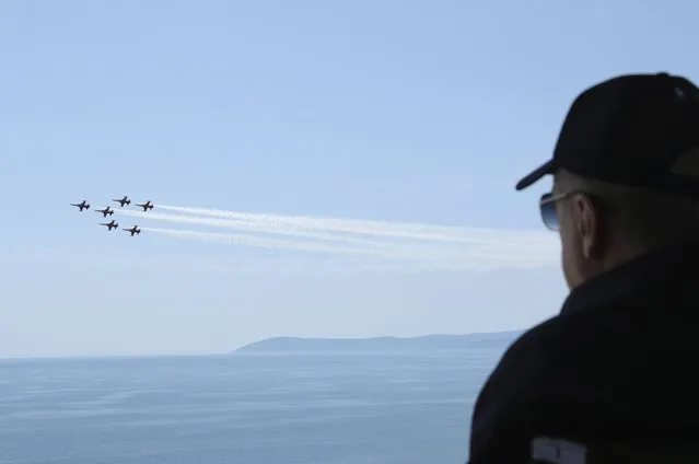 In this handout photo provided by the Turkish Presidency, Turkish President Recep Tayyip Erdogan watches jet fighters fly past during the final day of military exercises that were taking place in Seferihisar near Izmir, on Turkey's Aegean coast, Thursday, June 9, 2022. Erdogan on Thursday warned Greece to demilitarize islands in the Aegean, saying he was “not joking” with such comments. Turkey says Greece has been building a military presence on Aegean in violation of treaties that guarantee the unarmed statues of the islands. (Photo by Turkish Presidency via AP Photo)