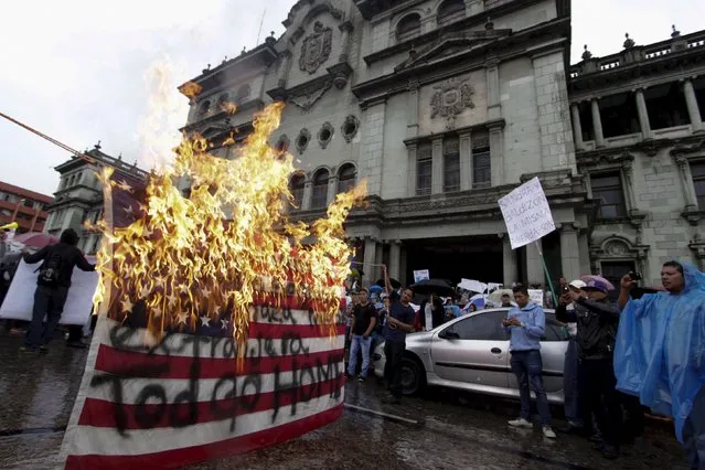 Demonstrators burn a U.S. flag during a protest to demand the resignation of Guatemala's President Otto Perez Molina, in Guatemala City, August 15, 2015. (Photo by Josue Decavele/Reuters)