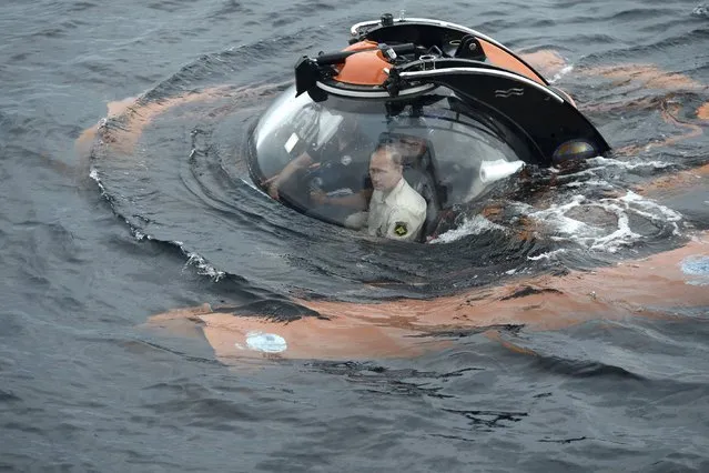 Russian President Vladimir Putin (front) is seen inside a research bathyscaphe while submerging into the waters of the Black Sea as he takes part in an expedition near Sevastopol, Crimea, August 18, 2015. (Photo by Alexei Nikolsky/Reuters/RIA Novosti/Kremlin)