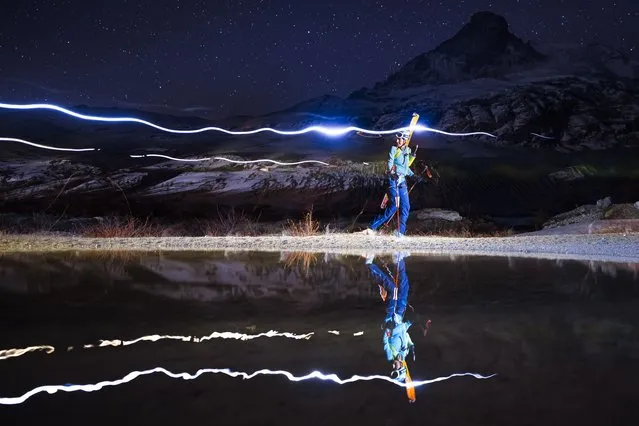 A competitor, shot using a long exposure, climbs in front of the iconic Matterhorn mountain after the start of the 22nd Glacier Patrol race in Ober Stafel, above Zermatt, Switzerland, 27 April 2022. The Glacier Patrol (Patrouille des Glaciers in French), organized by the Swiss Army, takes place during between 25 April and 01 May. Highly-experienced hiker-skiers trek over a distance of 57,5km (4386m ascent and 4519m descent) on the Haute Route along the Swiss-Italian border from Zermatt to Verbier. (Photo by Valentin Flauraud/EPA/EFE)