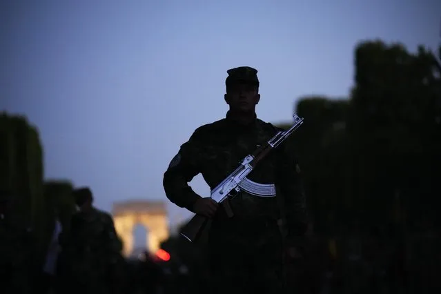Soldiers of Bulgaria stand on the Champs Elysees avenue during a rehearsal for the Bastille Day parade in Paris, France, Monday, July 11, 2022. Paris is preparing for a big Bastille Day parade later this week, a military show on the Champs-Elysees avenue that this year will honor war-torn Ukraine and include troops from countries on NATO's eastern flank: Poland, Hungary, Slovakia, Romania, Bulgaria, Czechia, Lithuania, Estonia and Latvia. (Photo by Christophe Ena/AP Photo)