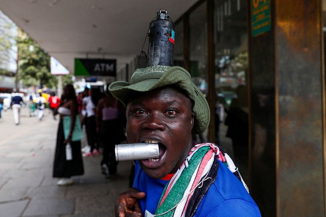 A man has a grenade attached to his head as activists and civil society members participate in a nationwide march titled “End Femicide Kenya” to raise awareness about gender-based violence (GBV) and to pressure the Kenyan government to implement stricter laws and policies to combat this pervasive issue, in downtown Nairobi, Kenya on December 10, 2024. (Photo by Thomas Mukoya/Reuters)
