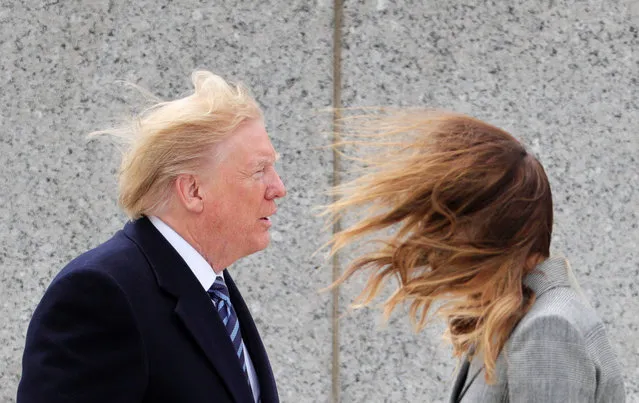 U.S. President Donald Trump and first lady Melania Trump brace themselves against strong winds during a Victory in Europe Day 75th anniversary ceremony at the World War II Memorial in Washington, U.S., May 8, 2020. (Photo by Tom Brenner/Reuters)