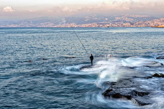 A photograph taken with a low shutter speed shows a fishing man during a sunny day at the Corniche al-Manara in Beirut, Lebanon,​ 16 September 2019. (Photo by Wael Hamzeh/EPA/EFE)