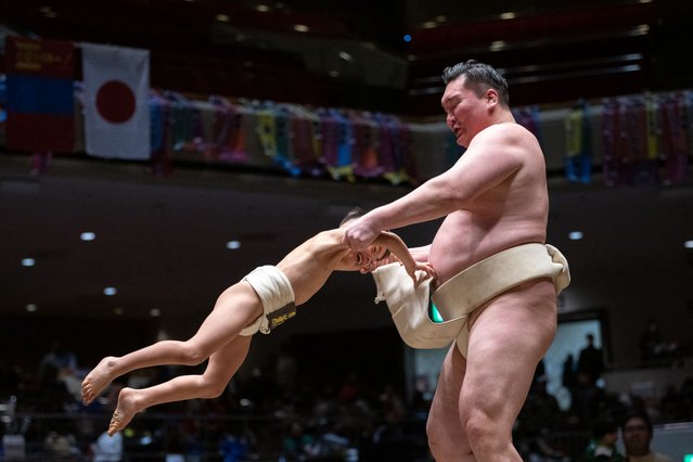 Retired Mongolian-born “yokozuna” wrestler Hakuho holds a young sumo wrestler during a class at the 15th Hakuho Cup, a competition for young sumo wrestlers from elementary and middle school, at the Kokugikan arena in the Ryogoku area of Tokyo on February 11, 2025. (Photo by Philip Fong/AFP Photo)