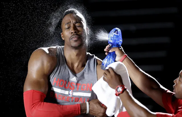 Houston Rockets center Dwight Howard is sprayed with water as he goes through a simulated workout while being filmed during NBA basketball media day, Monday, September 29, 2014, in Houston. (Photo by David J. Phillip/AP Photo)