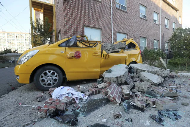 Debris from a collapsed wall that destroyed a vehicle is scattered in front of a kindergarten after an earthquake in Pohang, South Korea, Wednesday, November 15, 2017. A 5.4-magnitude earthquake struck off South Korea's southeastern coast Wednesday afternoon, but no casualties were immediately reported. (Photo by Kim Jun-beom/Yonhap via AP Photo)
