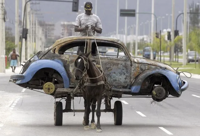 A Brazilian man transports on his horse-drawn cart the remains of a Volkswagen Beetle that caught fire and was abandoned by its owner in Rio de Janeiro, Brazil, in this July 25, 2005 file photo. EU regulators said on Tuesday they are in contact with Volkswagen AG and U.S. authorities following the car-makers' admission it had rigged emissions tests, and called on member states to rigorously enforce the relevant law. (Photo by Bruno Domingos/Reuters)