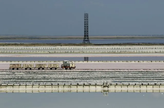 A train passes across the bed of a drained area of a lake used for the production of salt at the Sasyk-Sivash lake near the city of Yevpatoria, Crimea, September 25, 2015. (Photo by Pavel Rebrov/Reuters)