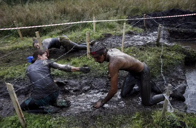 People take part in an extreme run competition in Zhodino, east of Minsk, September 26, 2015. (Photo by Vasily Fedosenko/Reuters)