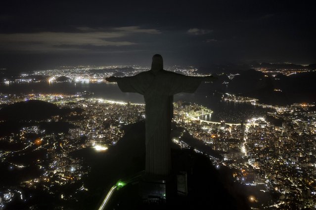 The Christ the Redeemer statue stands with its lights turned off during an hour of voluntary darkness for the global “Earth Hour” campaign in Rio de Janeiro, Brazil, Saturday, March 22, 2025. (Photo by Bruna Prado/AP Photo)