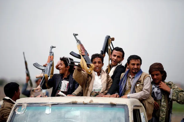 Tribesmen loyal to the Houthi movement ride on the back of a truck as they leave a tribal gathering they held to show support to a political council formed by the movement and the General People's Congress party to unilaterally rule Yemen by both groups in Sanaa, August 14, 2016. (Photo by Khaled Abdullah/Reuters)