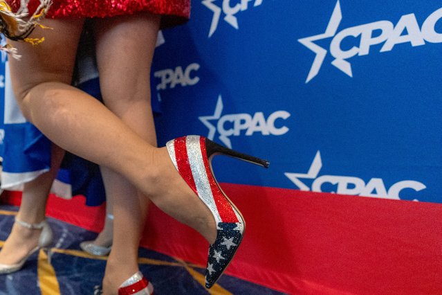 An attendee wears American flag themed shoes as she walks through the Conservative Political Action Conference, CPAC 2024, at the National Harbor in Oxon Hill, Md., Friday, February 23, 2024. (Photo by Alex Brandon/AP Photo)