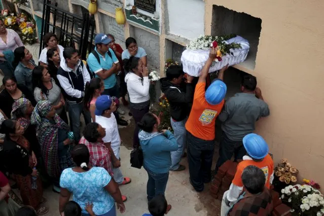 Relatives attend the funeral of two victims of a mudslide in Santa Catarina Pinula, on the outskirts of Guatemala City, October 3, 2015. (Photo by Jose Cabezas/Reuters)