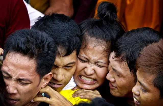 People a pushed together during the Black Nazarene procession in Manila, Philippines, January 9, 2013. The annual procession attended by hundreds of thousands of devotees is becoming a popular tourist attraction. (Photo by Aaron Favila/Associated Press)