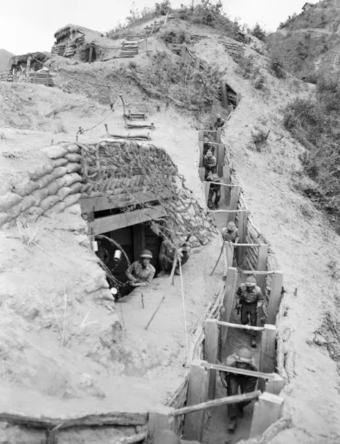 Soldiers of the 9th Republic of Korea (ROK) division move through well-built trenches on a dusty hill overlooking the east central front in Korea, May 26, 1957. Sandbagged bunkers reinforce the position. One of many defense points in which the ROK defenders, with no chance of evacuation, are dug in for a last ditch fight should the communists again move southward. Some United Nations commanders have termed the ROK positions superior to the more vulnerable U.S. defenses. (Photo by AP Photo/Sweers)