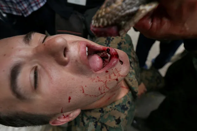 A U.S. Marine drinks the blood of a cobra during a jungle survival exercise as part of the “Cobra Gold 2018” (CG18) joint military exercise, at a military base in Chonburi province, Thailand, February 19, 2018. (Photo by Athit Perawongmetha/Reuters)
