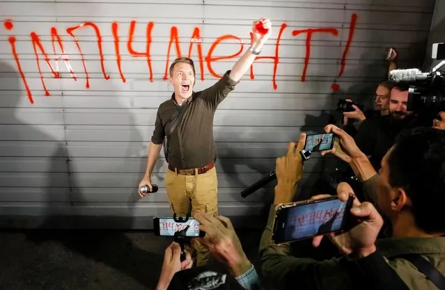An activist reacts as he wrote sign “Impeachment” during a rally in front of the Presidential residence near Kiev, Ukraine, 10 September 2020. Activists protest against the joint inspection with pro-Russian militants representatives the Ukrainian army positions in the area of the inhabited locality of Shumy which was planned on 10 September because it legalizes them like the subject of conflict and moves Russia from conflict side to observer status. The participants in the Trilateral Contact Group (TCG) meeting agreed on a joint inspection in the area of the inhabited locality of Shumy with the participation of representatives of the OSCE coordinator and pro-Russian militants on 09 September. The joint inspection has been suspended on 10 September due the Ukrainian side had received a number of demands that contradict each other, as well as distorting the nature of the ceasefire agreements and humiliating the OSCE as a reliable and objective mediator as the presidential office reported. (Photo by Sergey Dolzhenko/EPA/EFE)
