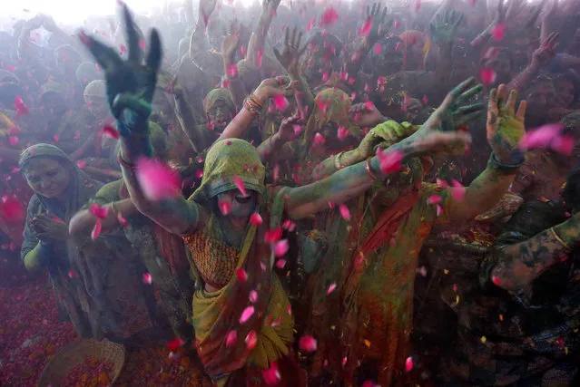 Hindu devotees dance during Holi celebrations inside a temple in Ahmedabad, India on March 2, 2018. (Photo by Amit Dave/Reuters)