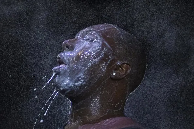 A man is doused with milk and sprayed with mist after being hit by an eye irritant from security forces trying to disperse demonstrators protesting against the shooting of unarmed black teen Michael Brown in Ferguson, Missouri, in this August 20, 2014 file photo. (Photo by Adrees Latif/Reuters)