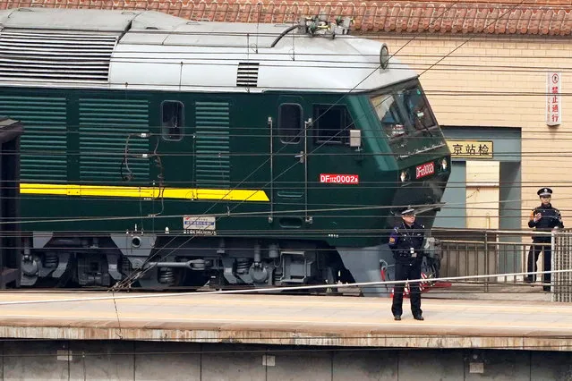 Police officers keep watch next to a train at the Beijing Railway Station in Beijing, China March 27, 2018. (Photo by Jason Lee/Reuters)