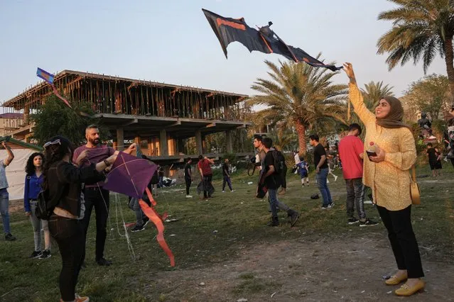 People take part in the Baghdad Kite Festival in Baghdad, Iraq, Friday, March 17, 2023. (Photo by Hadi Mizban/AP Photo)