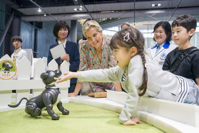 The Duchess of Edinburgh looks at a robot dog with Yumi Takeyama, aged 6, during a visit to Miraikan, The National Museum of Emerging Science in Tokyo, which pioneers cutting-edge science and technology related to themes such as space, the global environment, and robotics, on day two of the royal trip to Japan on Saturday, September 20, 2025. (Photo by Jane Barlow/PA Wire)
