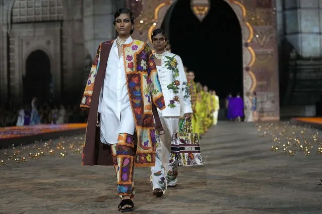 Models display creations for the Dior Pre-Fall 2023 collection at the Gateway of India landmark monument in Mumbai, India, Thursday, March 30, 2023. (Photo by Rafiq Maqbool/AP Photo)