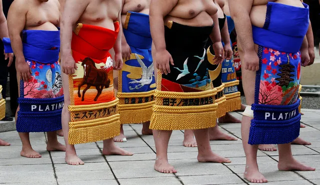 Sumo wrestlers pray during a ritual ceremony at the start of an annual sumo tournament dedicated to the Yasukuni Shrine in Tokyo, Japan on April 16, 2018. (Photo by Toru Hanai/Reuters)