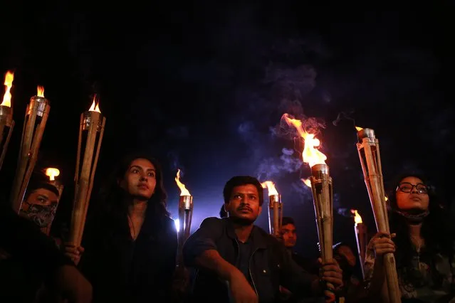 Students hold torches during an anti-fundamentalism protest in Dhaka, Bangladesh on December 5, 2020. Bangladeshi several Islamic groups protesting continue against the installation of the sculpture of the countrys founding President Sheikh Mujibur Rahman and demanded demolition of human statues. (Photo by Rehman Asad/NurPhoto via Getty Images)