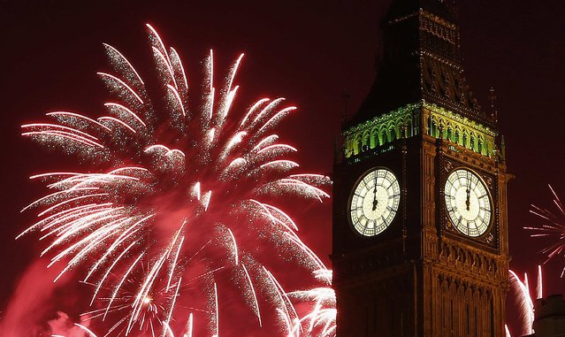 Fireworks explode behind the Houses of Parliament and Big Ben on the River Thames during New Year's celebrations in London January 1, 2015. (Photo by Suzanne Plunkett/Reuters)