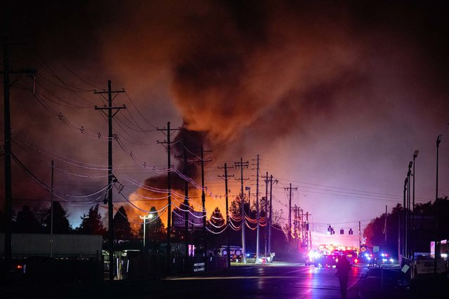 Plumes of smoke rise in Louisville, Kentucky, after a UPS cargo plane crashed shortly after takeoff on Tuesday, November 4, 2025. At least 13 people were killed in the crash, which destroyed some businesses and buildings near the airport. The cause of the crash is under investigation. (Photo by Jon Cherry/AP Photo)
