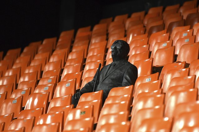 A statue representing a former fan is pictured ahead of the Champions League round of 16 second leg soccer match between Valencia and Atalanta in Valencia, Spain, Tuesday March 10, 2020. The match is being in an empty stadium because of the coronavirus outbreak. (Photo by UEFA via AP Photo)