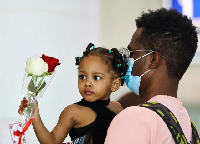 Man and child evacuated from Sudan to escape the conflicts arrive in Abu Dhabi airport, United Arab Emirates on April 29, 2023. (Photo by Rula Rouhana/Reuters)