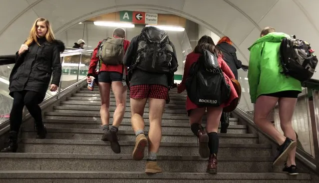 Passengers not wearing pants walk up the stairs through a subway train transfer tunnel during the “No Pants Subway Ride” in Prague January 11, 2015. (Photo by David W. Cerny/Reuters)
