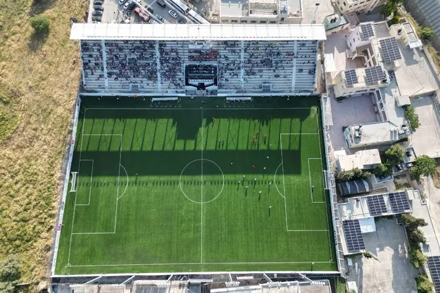 An aerial picture shows a football match between Jordan and Palestine during the inauguration of the newly-renamed Pele Stadium in al-Khader village in Bethlehem, on May 14, 2023. (Photo by Hazem Bader/AFP Photo)