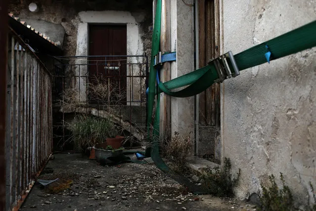 Thick belts are tied around a building to prevent further damage after it was damaged by a strong earthquake, near the old centre of the town of Catsel Vecchio in the province of L'Aquila in Abruzzo, inside the national park of the Gran Sasso e Monti della Laga, Italy, September 11, 2016. (Photo by Siegfried Modola/Reuters)