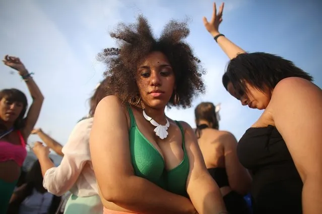 NEW YORK, NY - JUNE 22:  Revelers dance at the 2013 Mermaid Parade at Coney Island on June 22, 2013 in the Brooklyn borough of New York City. Coney Island was hard hit by Superstorm Sandy but parade organizers, whose offices were flooded, were able to raise $100,000 on Kickstarter to fund the parade. The Mermaid Parade began in 1983 and features participants dressed as mermaids and other sea creatures while paying homage to the former tradition of the Coney Island Mardi Gras, which ran annually in the early fall from 1903-1954.  (Photo by Mario Tama/Getty Images)