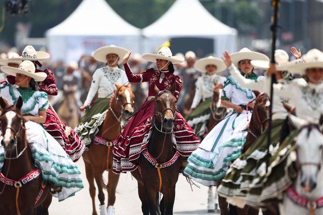 Women in traditional dresses ride horses during the parade celebrating Independence Day hosted by President Andres Manuel Lopez Obrador, his last one before he finishes his term on October 1, in Mexico City, Mexico on September 16, 2024. (Photo by Raquel Cunha/Reuters)