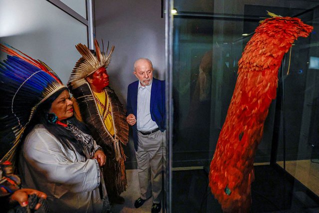 Brazil's President Luiz Inacio Lula da Silva accompanied by Sonia Guajajara, the Minister of Indigenous People, looks on at the Tupinamba cloak, a feathered ceremonial cape used in religious rituals, during a ceremony at Brazil's National Museum in Rio de Janeiro, Brazil on September 12, 2024. (Photo by Ricardo Stuckert/Brazil Presidency/Handout via Reuters)