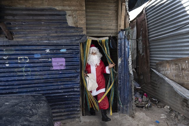 Cinthia Falcon leaves the house where she dressed up as Santa Claus to gift presents to children at a pre-Christmas celebration organized by “Los Chicos de la Via” soup kitchen in Buenos Aires, Argentina, December 14, 2024. (Photo by Rodrigo Abd/AP Photo)