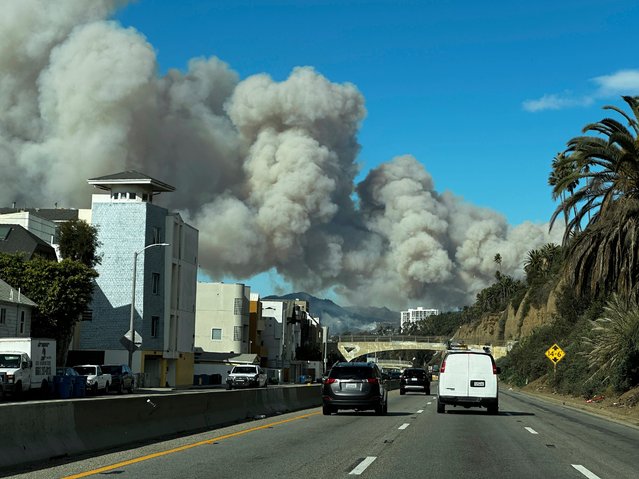 Heavy smoke from a brush fire in the Pacific Palisades rises over the Pacific Coast Highway in Santa Monica, Calif., on Tuesday, January 7, 2025. (Photo by Eugene Garcia/AP Photo)