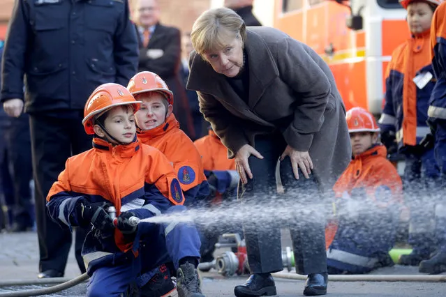 German Chancellor Angela Merkel visits a youth fire brigade at Wedding in Berlin, Germany, November 14, 2016. (Photo by Axel Schmidt/Reuters)