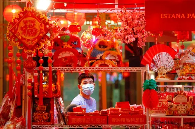 Man wearing a protective mask shops for decorations at a shopping mall ahead of the Lunar New Year in Jakarta, Indonesia, February 11, 2021. (Photo by Ajeng Dinar Ulfiana/Reuters)