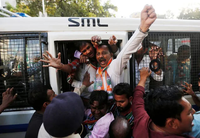 Supporters of India's main opposition Congress party shout slogans from a police vehicle after being detained during a protest against the government's decision to withdraw 500 and 1000 Indian rupee banknotes from circulation, in Ahmedabad, India, November 23, 2016. (Photo by Amit Dave/Reuters)