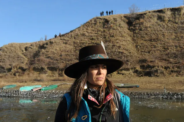 A protester reacts to the new barbed wire placed around Turtle Island during a protest against plans to pass the Dakota Access pipeline near the Standing Rock Indian Reservation, near Cannon Ball, North Dakota, U.S. November 25, 2016. (Photo by Stephanie Keith/Reuters)